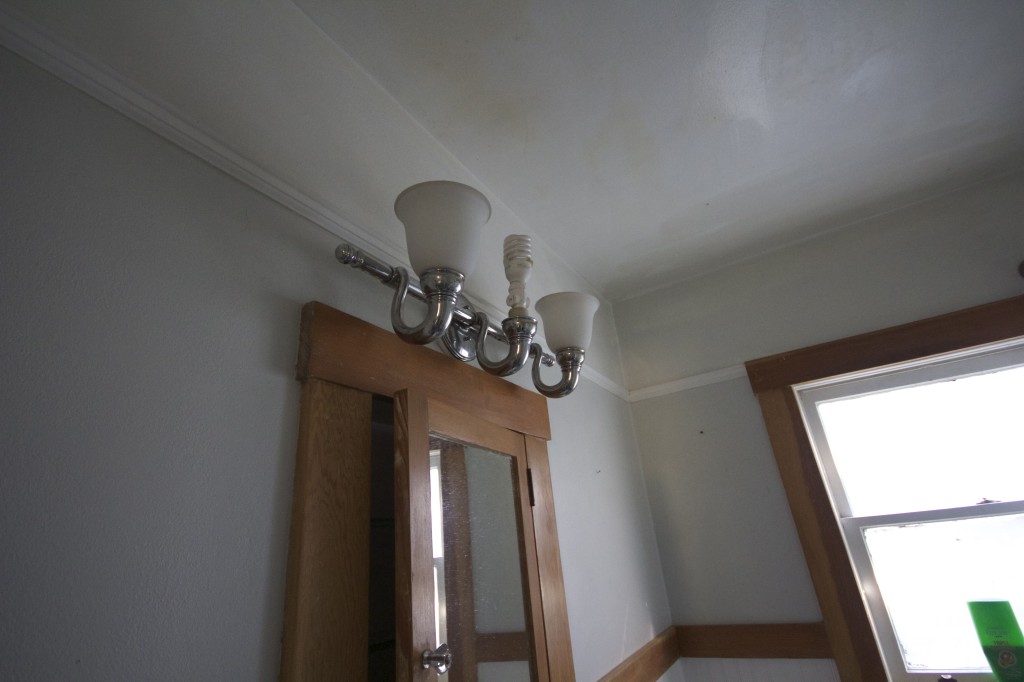 There are zero outlets in the bathroom so they screwed an adapter into the light fixture.  Classy.